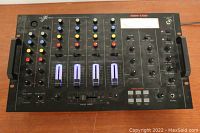 Full top view of NexXtech SSM-1750 mixer with illuminated channel sliders and control knobs.