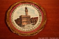 Front view of the decorative plate showing Firenze Palazzo Vecchio with gold and reddish border detail.