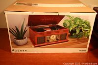 Box of Victrola Le Walden turntable stereo system showing product image and brand on packaging.