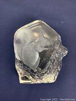 Crystal sculpture from two angles showing detailed squirrel engraving inside clear crystal block with tree branch base.