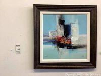 Frontal view of framed abstract print on wall showing full composition and frame