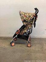 Side view of Maclaren stroller showing patterned canopy, seat, and frame structure