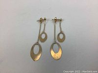 Full view of both earrings flat on white background