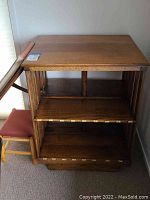 Full view of oak shelf next to matching stool