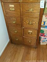 Front view: oak two-column eight-drawer cabinet on casters