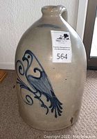 Front view of jug showing cobalt blue bird motif on light gray salt-glazed surface