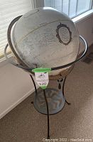 Full view of Replogle 16 inch diameter floor globe with platinum map in metal stand with sun motif base.