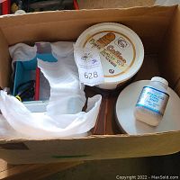 All items in cardboard box: tumbler unit, media bucket, bowl, lid, shot jar