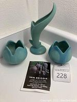 Group shot of two small tulip vases and one tall flower form vase with auction catalog card visible