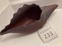 Top and side view showing scalloped opening and interior of conch shell vase