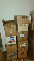 Stacked cardboard boxes containing yarn and fabric