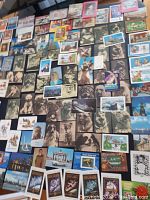 Overview of all 108 vintage Russian pocket calendar cards spread out, showing a variety including dog portraits, scenic views, and Soviet-related imagery with a mix of colors and sepia tones.