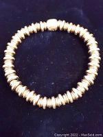 Top-down view of bracelet on dark background showing overall design and bead arrangement.