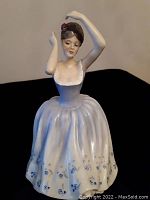 Front view of Royal Doulton figurine Sheila showing facial features, bodice and skirt with floral details.