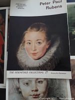 Close-up photo of one plate showing a portrait of a young woman with a ruffled collar, titled Peter Paul Rubens, part of The Hermitage Collections by Aurora Art Publishers