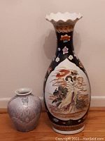 Pair of Asian vases showing both items together to highlight size difference and overall appearance.