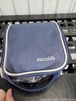 Blue Microlife zippered carrying case containing the blood pressure machine