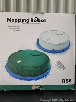 Front view of the boxed RS6 Mopping Robot with images of dark green and white color options and text describing features like imitation hand rub, dry and wet use, and low noise operation.