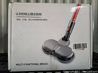 Photo of retail packaging for the multi-functional brush head accessory compatible with Dyson V6 vacuums showing product image and branding in English and Chinese.