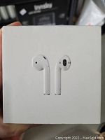 Front of box showing image of Apple AirPods earbuds.