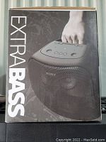 Front of box showing ‘EXTRA BASS’ branding and photograph of speaker with carry handle.