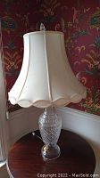Full view of Waterford crystal lamp with cream fabric shade, showing lamp base and shade details.