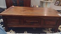 Front and top view of wooden coffee table showing drawer and wood grain finish