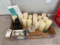 Full lot including LED candles of various sizes, Buddha figurine, lotus candle holder, derma roller kit items in cardboard box.