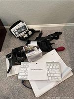 Complete lot showing all items including glucose meter kit, Polar heart rate bands, Apple wireless keyboard, personal massager, and Wi-Fi repeater.