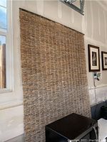 Full view of the large woven twig wall hanging hanging on a wall, showing its size and texture.