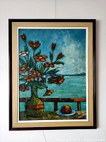 Framed oil painting showing still life of flowers in vase and fruit on plate with water horizon background