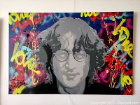 Front view of canvas painting showing multicolor abstract background and central grayscale portrait of John Lennon.
