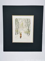 Matted artwork showing full etching with winter pathway, trees, benches, and figure with umbrella under snow-covered branches with city buildings in distance.