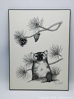 Full view of the framed black and white print showing the animal, pine branches, pinecones, and butterfly, hand signed by Steve McNorton.