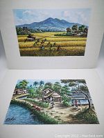 Photo of two watercolour paintings by G. Yahya, one showing rural field workers and a mountain background, the other a village scene by water with trees and houses.