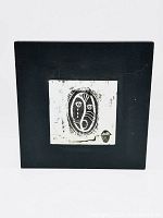 Frontal photo of the enamel artwork in its black frame, showing the overall composition and condition.