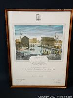 Framed print showing Toronto waterfront scene with wooden buildings, boats, and people.