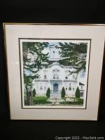 Full view of the framed limited edition print showing the large white house surrounded by pine trees and a picket fence.