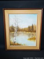 Framed original vintage painting showing autumn landscape with birch trees, water reflection, forest, and sky.