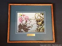 Framed Robert Bateman print with name plate shown fully in wooden frame and dark green matte.