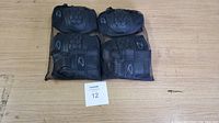 Full set of 12 black protective gear items including 4 knee pads, 4 elbow pads, 4 wrist guards all packed in a mesh bag.