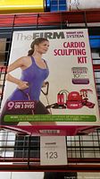 Front side of box showing kit title, main components visual, and key features including 9 express workouts on 3 DVDs.