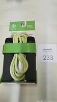 Front view of Gaiam adjustable speed rope showing foam handles and coiled plastic coated wire in original packaging with green band.