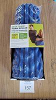 Front view of blue Gaiam Restore Deep Tissue Foam Roller in packaging showing label with product features and user image.