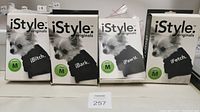 Four boxed iStyle dog shirts in size Medium, phrases iBitch, iBark, iPaw'd and iFetch visible on boxes