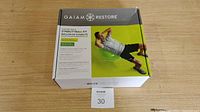 Box front and top showing Gaiam Restore Strong Back Stability Ball Kit with image of man exercising on green stability ball.