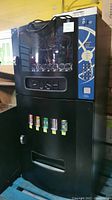 Overall front view showing snack coil rows and beverage graphic panel.