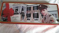 Top view of rectangular Elvis Presley Christmas-themed tin with holiday graphics and soldier uniform image.