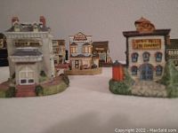 Close-up front view showing details of multiple buildings including Liberty Falls Fire Company and a news office