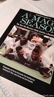 Cover of the book 'A Magic Season' showing Mariners players celebrating.